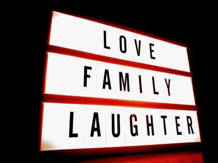 white and red led signage with love family laughter text